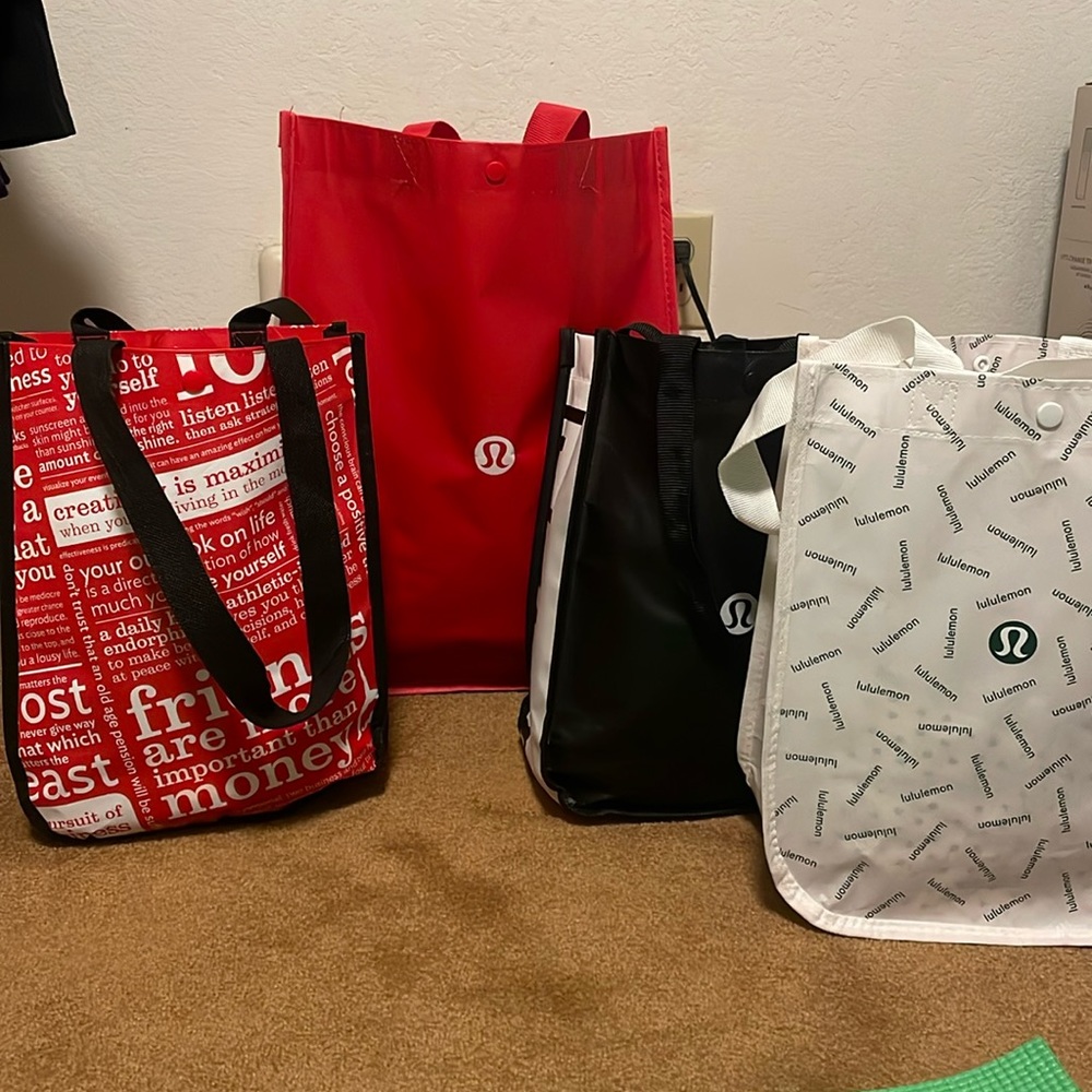 4 lululemon shopping bags. One large and three small